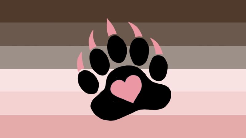 Flag with 6 horizontal stripes in the color order form top to bottom being brown, lighter brown, even lighter brown, light baby pink, darker baby pink, and even darker baby pink. There is a slightly tilted black bear paw print in the center of the flag with baby pink claws and a baby pink heart in the center of the main paw pad. 