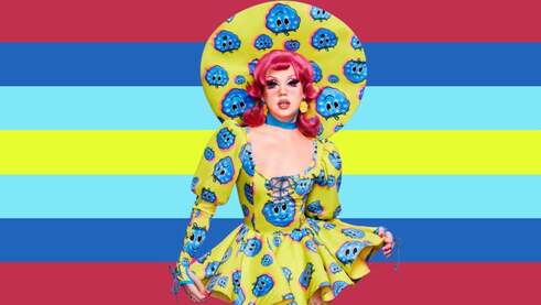 flag with 7 horizontal stripes in the color order of berry red, blue, electric blue, highlighter yellow, electric blue, blue, and berry red. There is a cutout of Willow Pill in her promo look on the flag. The promo look is her in highlighter yellow and some blues, some of the blues being the blueberry prints on her dress and big hat. She also has berry red hair. 