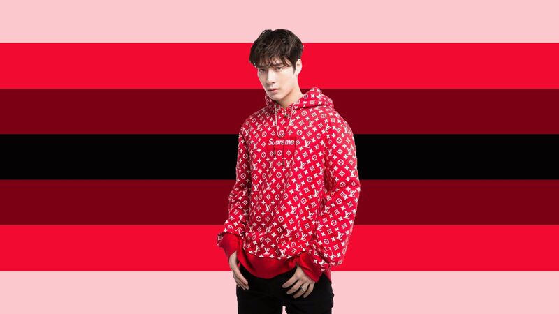 Flag with 7 horizontal stripes being pastel pink, red, dark red, black, dark red, red, and pastel pink. There is a cutout on the flag of Jackson Wang in those colors. 