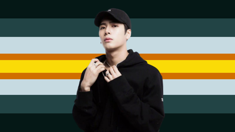 flag with 9 horizontal stripes. All are the same size except two thin stripes on either side of the middle yellow stripe being thin dark orange stripes. Then going outward on either side is a grey stripe, a blue-grey stripe, and a dark blue-grey stripe. There is a sticker of Jackson Wang on the flag wearing a black hoodie and ballcap.