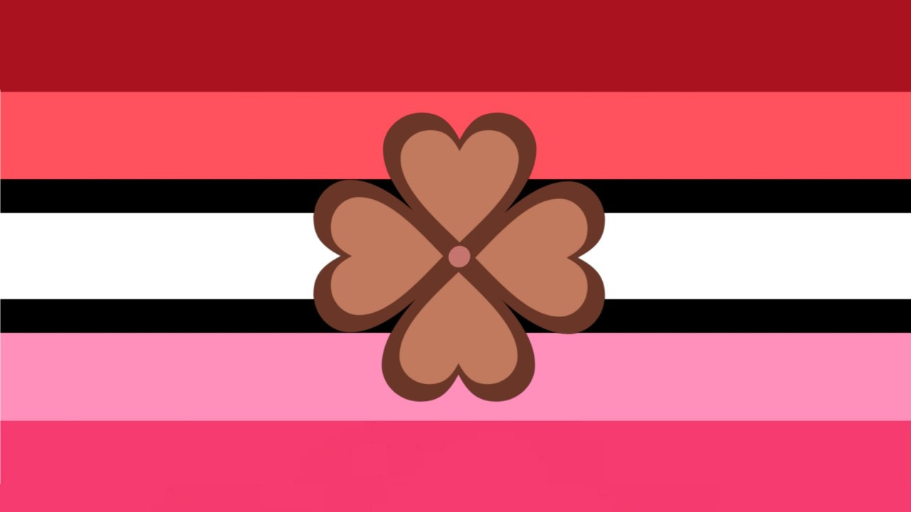 flag with 7 horizontal stripes. all the stripes are similar in size besides the stripes on either side of the middle white stripe being thin and black. The top two stripes are dark red and pale red. The last stripe is darker pink with the stripe above it being light pink. There is a brown flower in the center of the flag with 4 heart petals, similar to a four leaf clover.