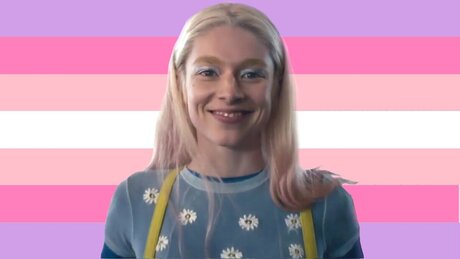 flag with 7 horizontal stripes. From top to bottom they are lilac, pink, baby pink, white, baby pink, pink, and lilac. There is a cutout sticker of Jules from Euphoria on the flag. 