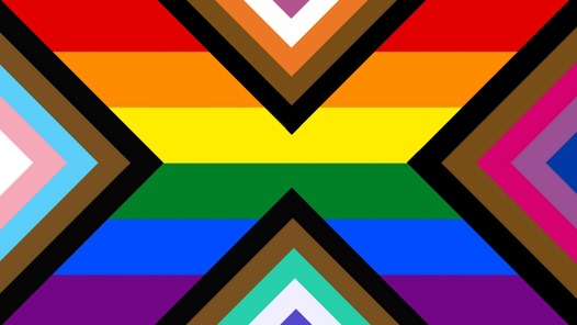 rainbow flag with a triangle on the left side with smaller triangles in it that start from black, brown, baby blue, baby pink, and then the smallest one being white. on the right is a triangle that goes black, brown, dark pink, purple, and dark blue. on the top is a triangle that goes black, brown, orange, white, and magenta. on the bottom is a triangle that goes black, brown, teal, white, and indigo.